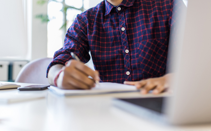 Man writing in notepad